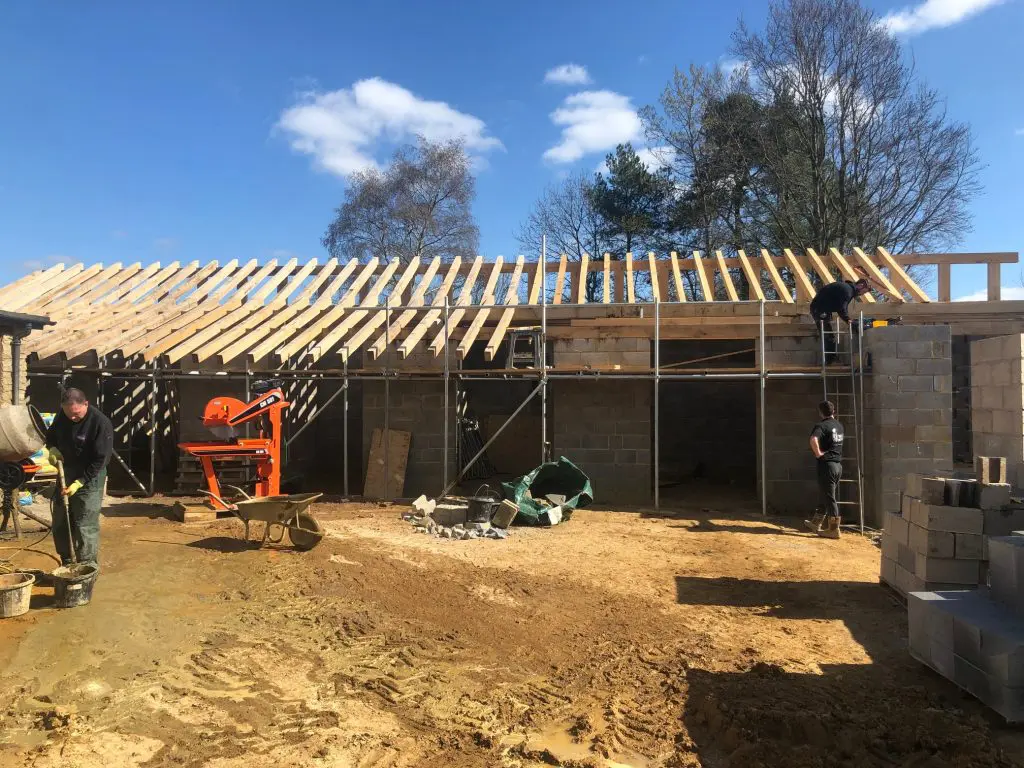 Partially built roof structure using custom cut fresh sawn oak beams