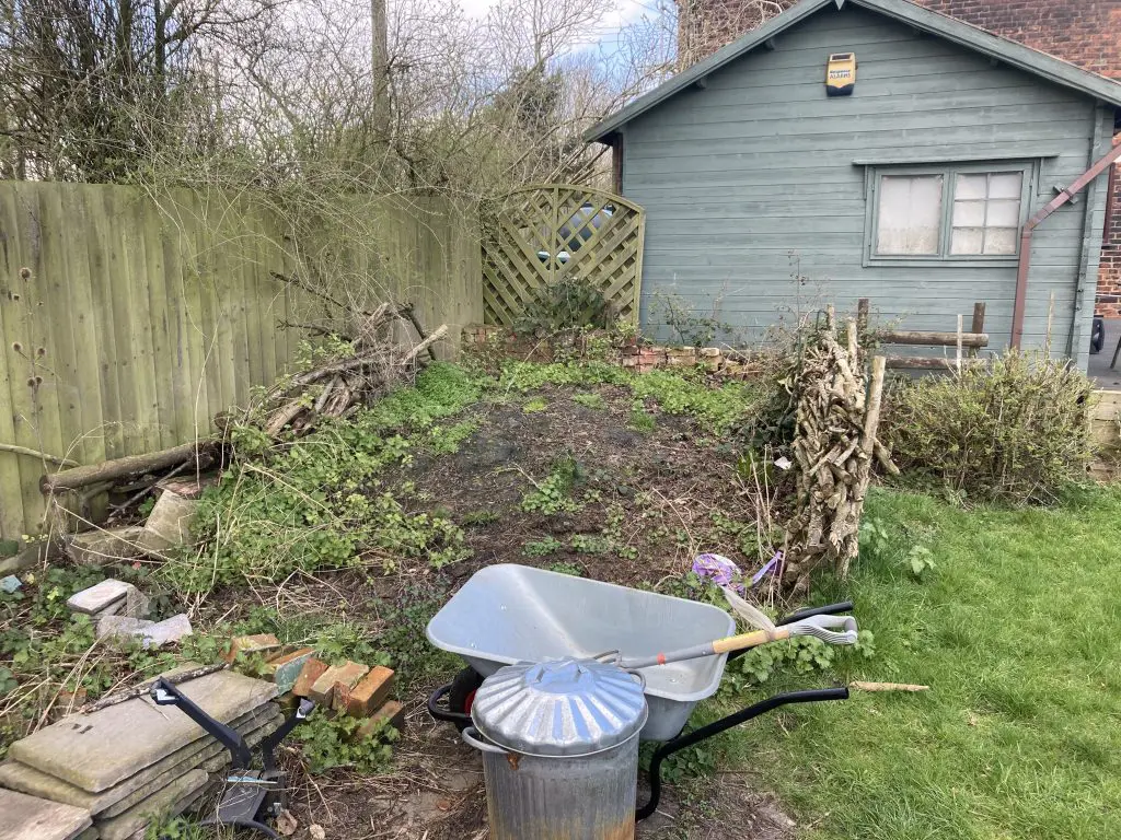 A garden shown before the outdoor seating area was created using Siberian Larch materials.