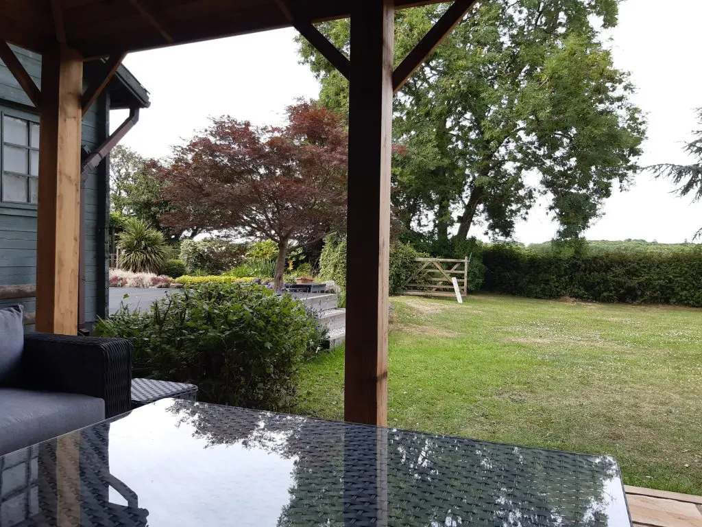 An outdoor area sheltered using Siberian Larch materials.