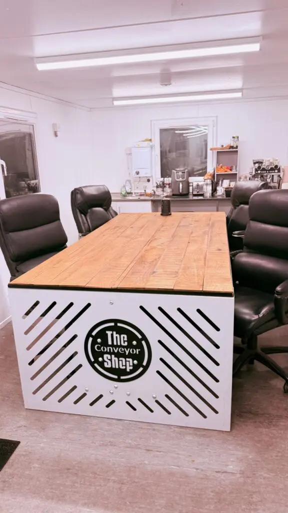 a photo of a meeting room table made out of solid oak gravel boards joined together.