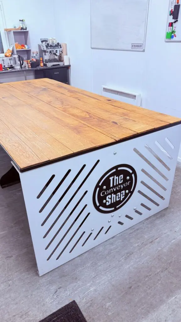 a photo of a meeting room table made out of solid oak gravel boards joined together.