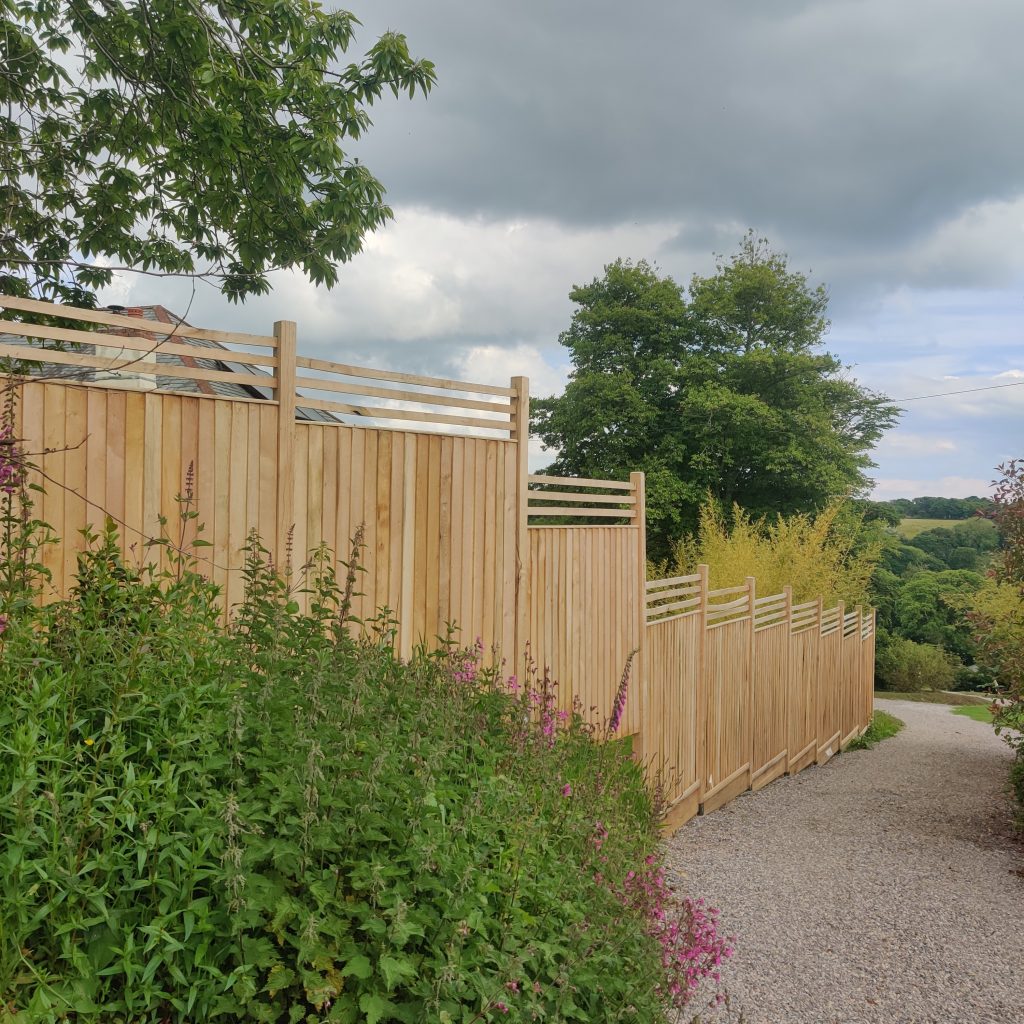Photo of a garden with Oak Featheredge Fence Panels running down the edging of the property