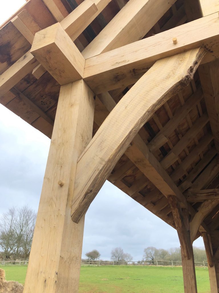 Fresh sawn oak beams that have been joined together to create a roof truss