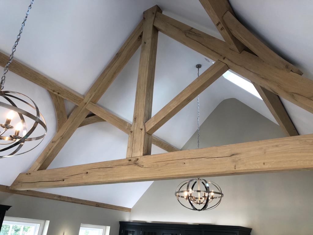 King Post Truss Internal Structure made out of green oak beams that have been joined together inside a house.