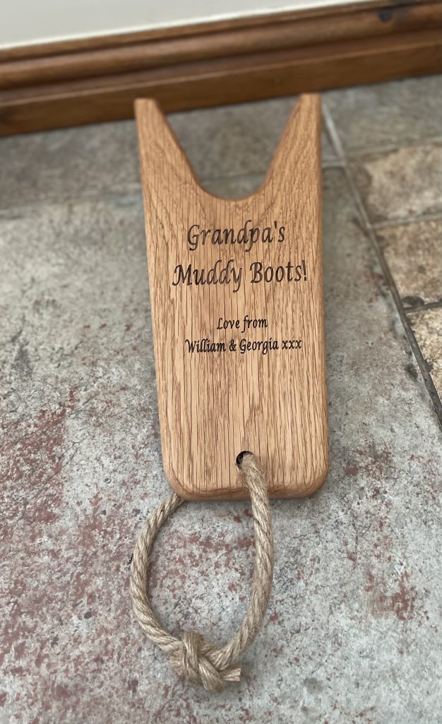 A wooden bottle opener engraved with a rope to hook it on