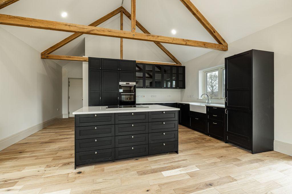 Indoor shot of an unfurnished kitchen with oak exposed beams