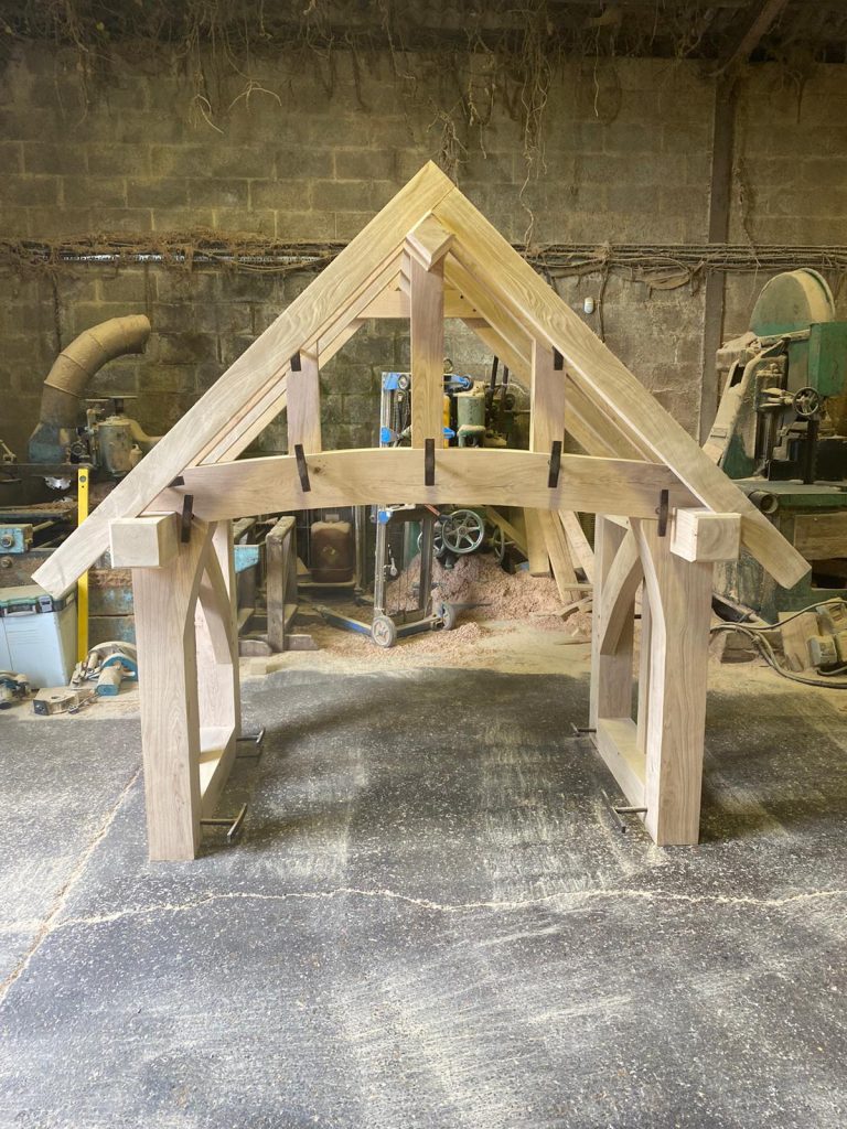 Custom cut fresh sawn oak beams used to create a porch that is ready to be fitted.