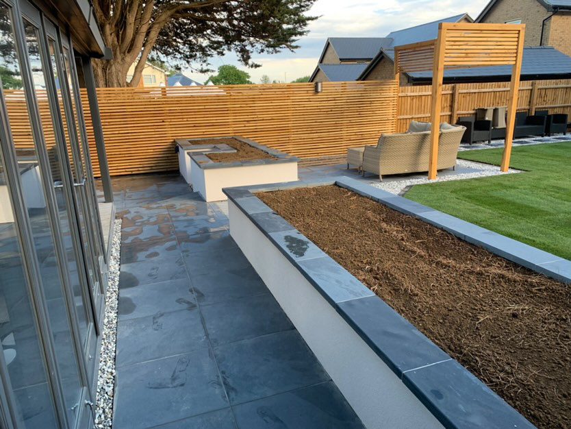 Siberian larch fencing battens used to create a border in a back garden for sleek and modern aesthetic