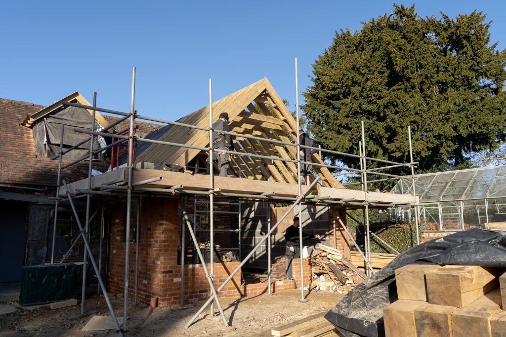 A progress photo of the construction of the extension including the structural green oak beams from uk timber